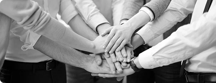 Hands stacked together, representing teamwork