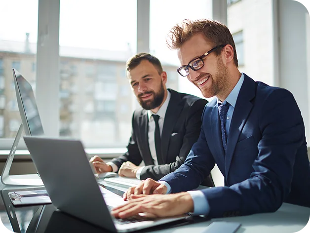 Business professionals collaborating on a laptop
