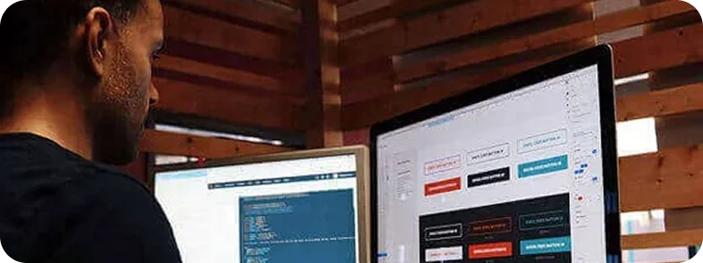 Website designer working with computer screens